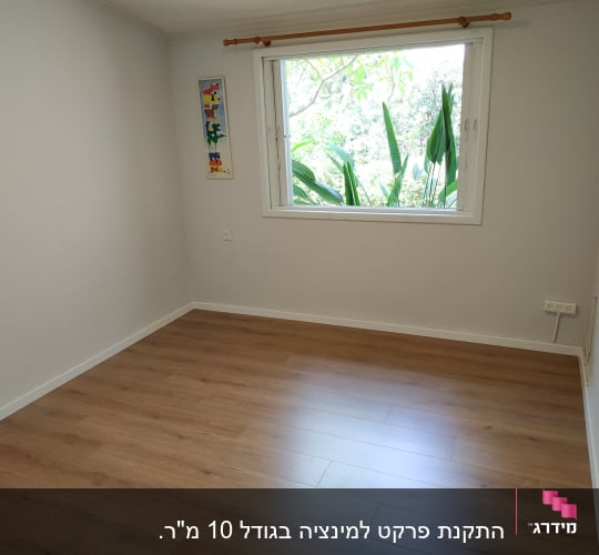 רצפת פרקט עץ בחדר ריק עם חלון